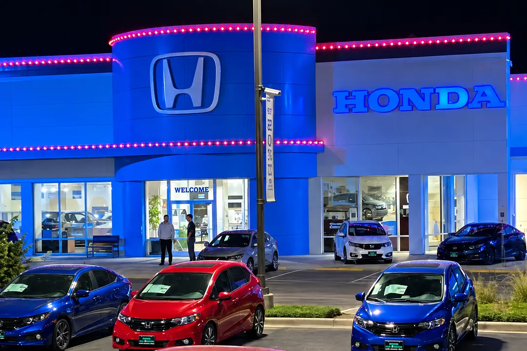 The Honda tower and entrance at Honda San Marcos, with two straight runs of lights along the tower top and the parapet.