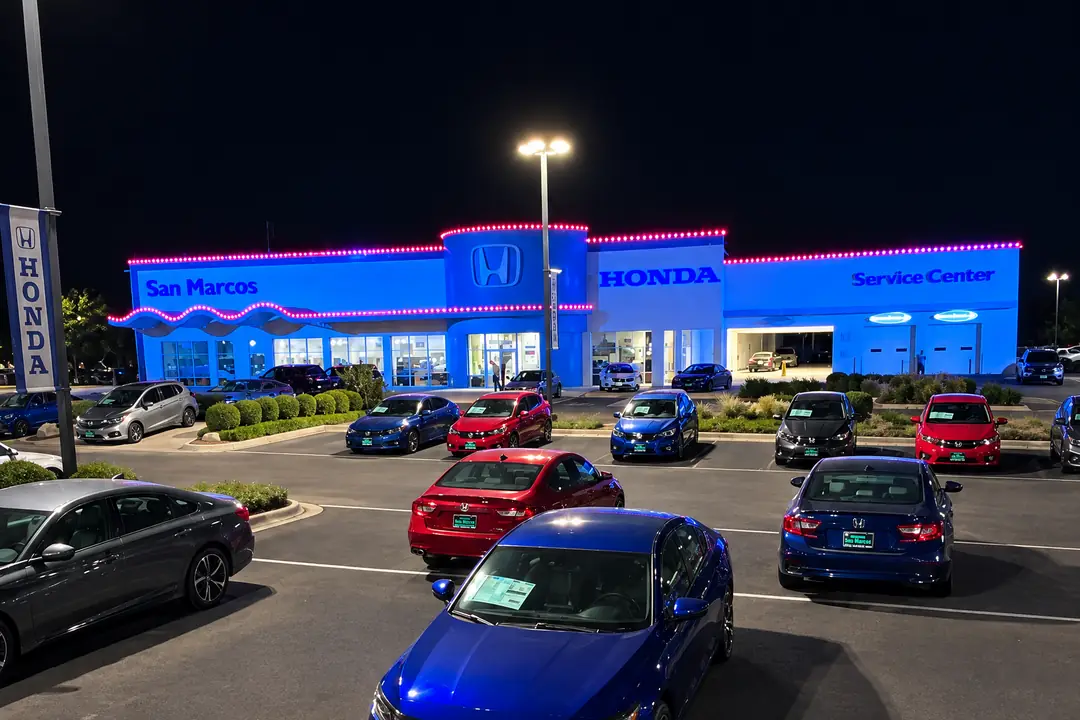 Honda San Marcos seen from above the car lot, the full lit roofline running from the showroom to the service center.